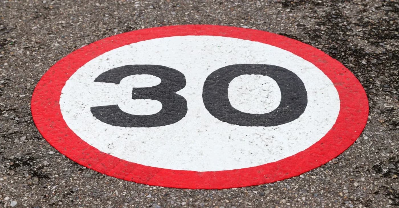 number 30 painted inside a circle on concrete