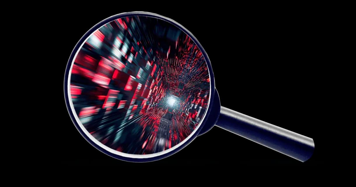 magnifying glass with red and black cubes inside