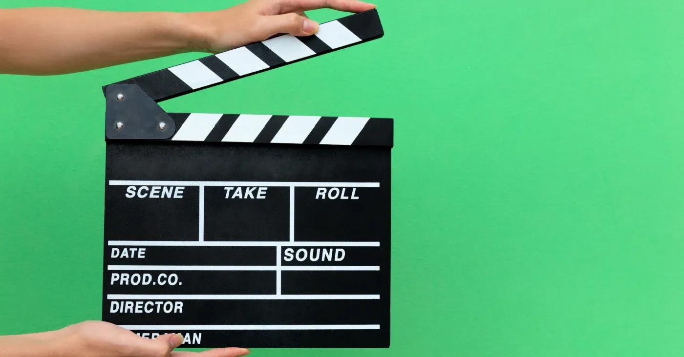 clapboard in front of green screen