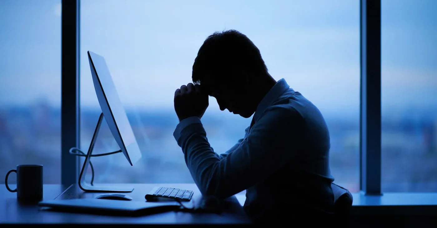 distressed tired man at computer