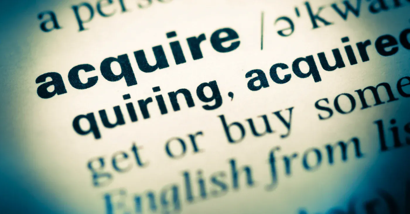 closeup of the word acquire in a dictionary
