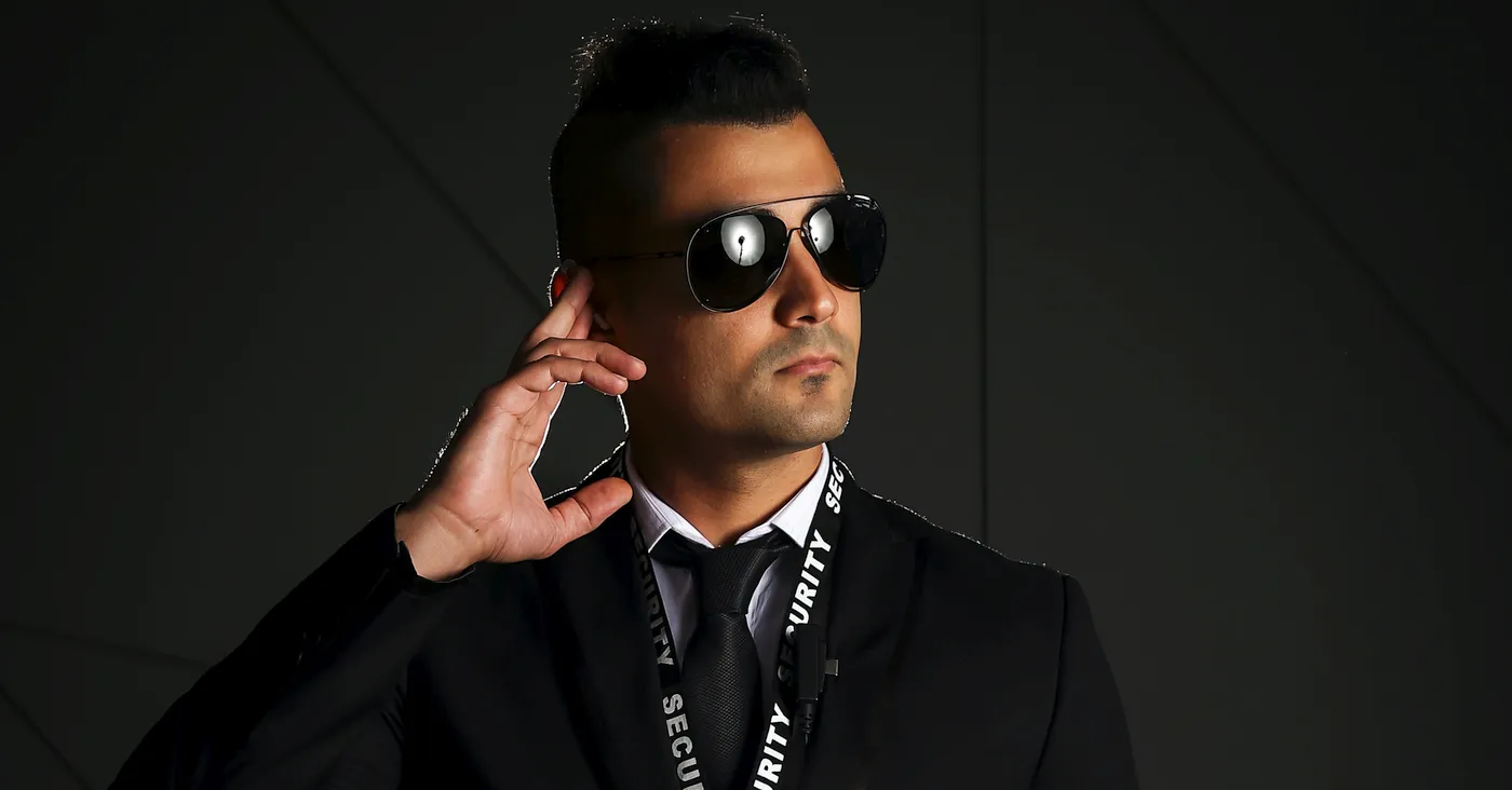 sleek security officer wearing sunglasses
