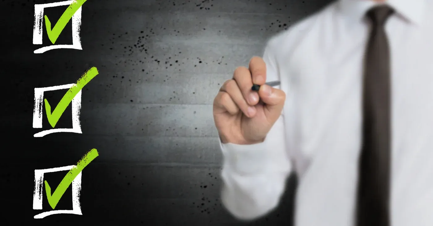 man with pen checking three boxes