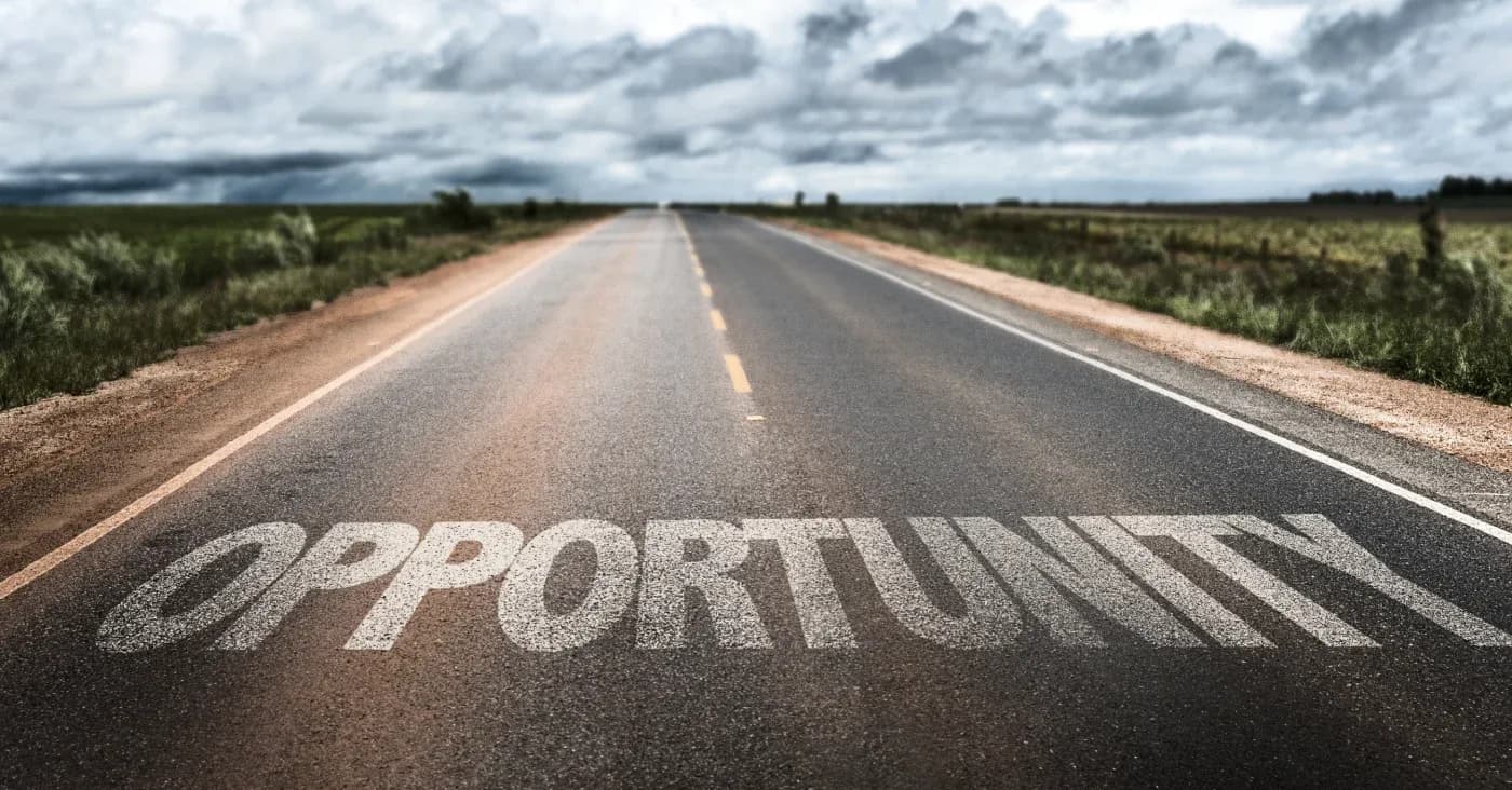 road with the word opportunity spanning the lanes