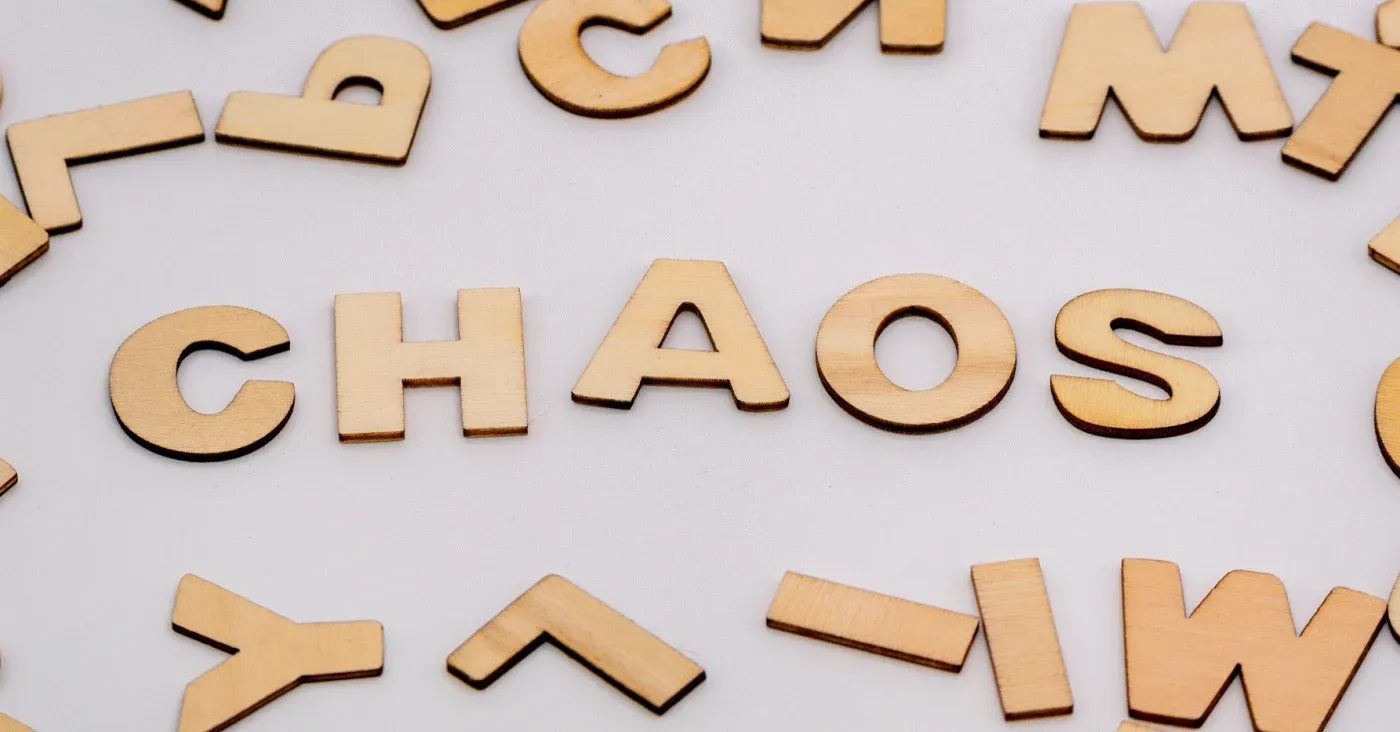wooden block letters scattered with the word chaos spelled in the center