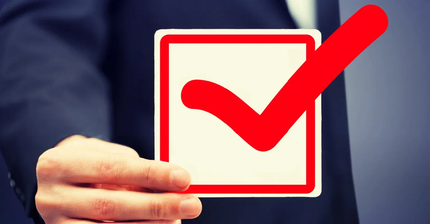 person holding up a check mark