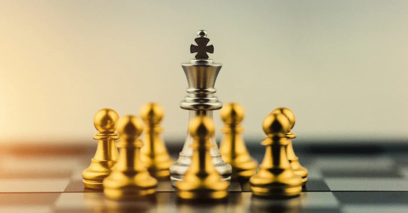 king chess piece surrounded by gold pawns