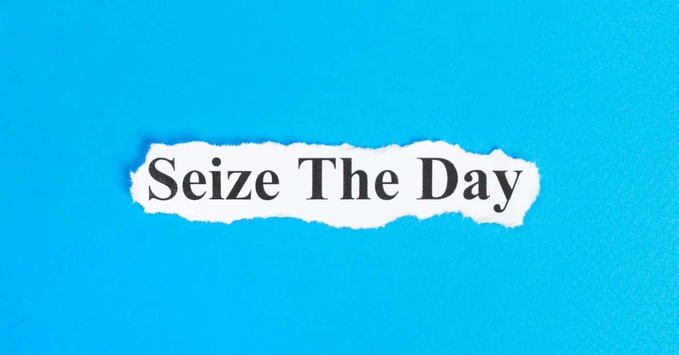 seize the day printed on ripped paper blue background