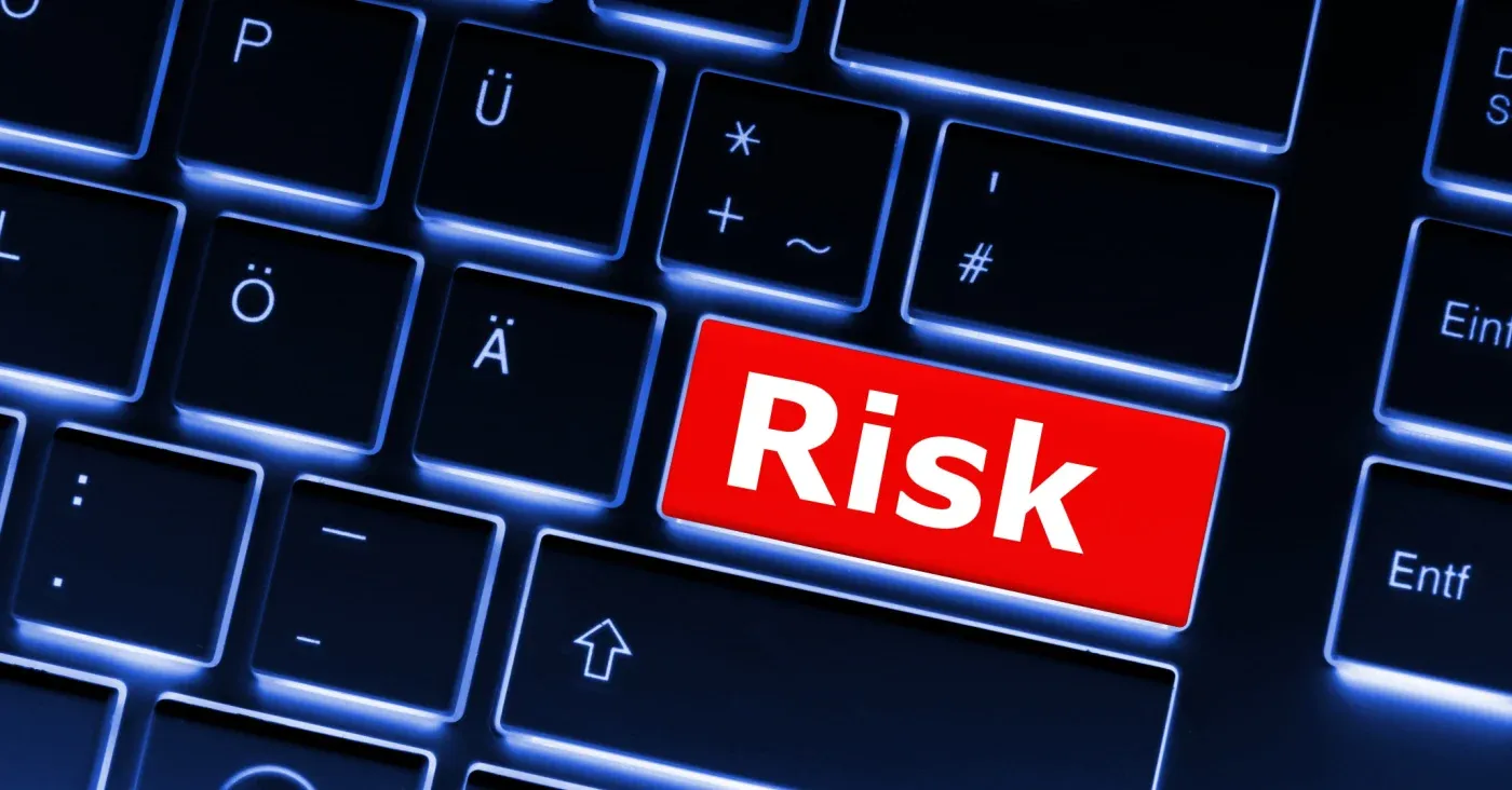 red highlighted key saying risk on computer keyboard
