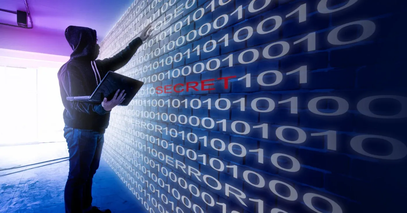 man looking at wall of binary code red word secret embedded in numbers