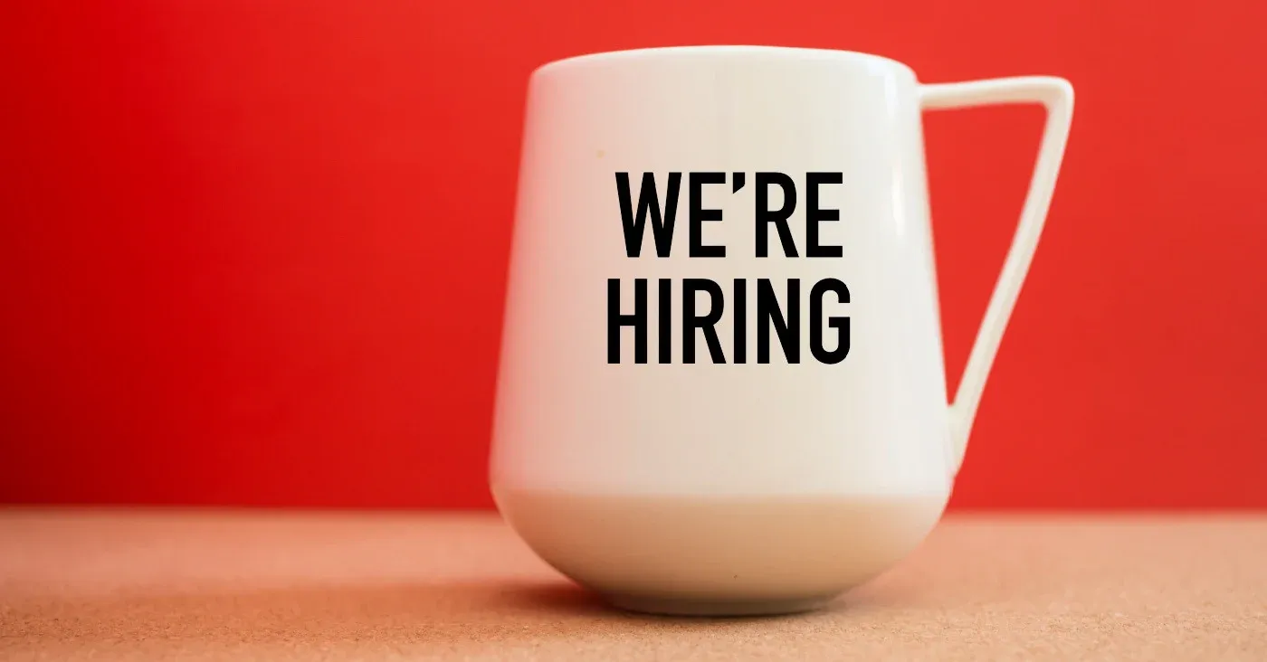 mug with text that says we're hiring