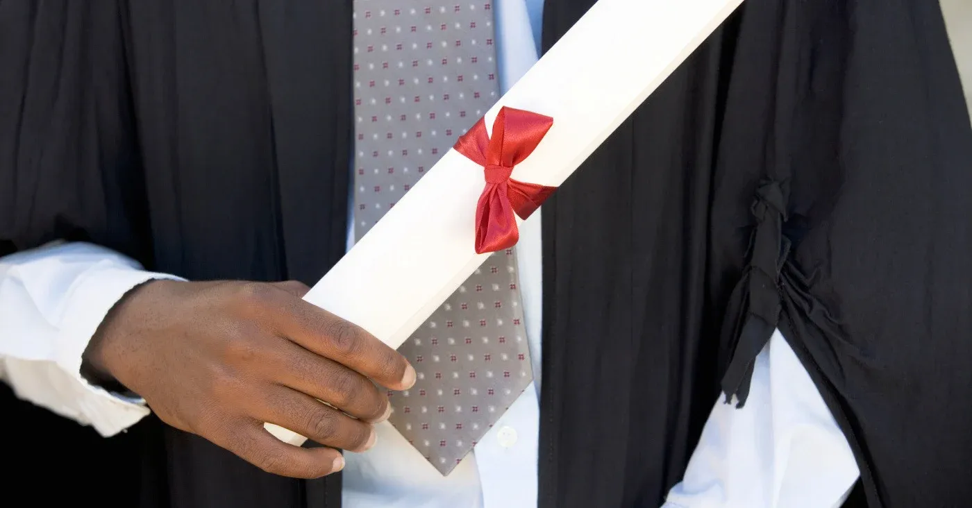 man holding scroll tied with red silk ribbon