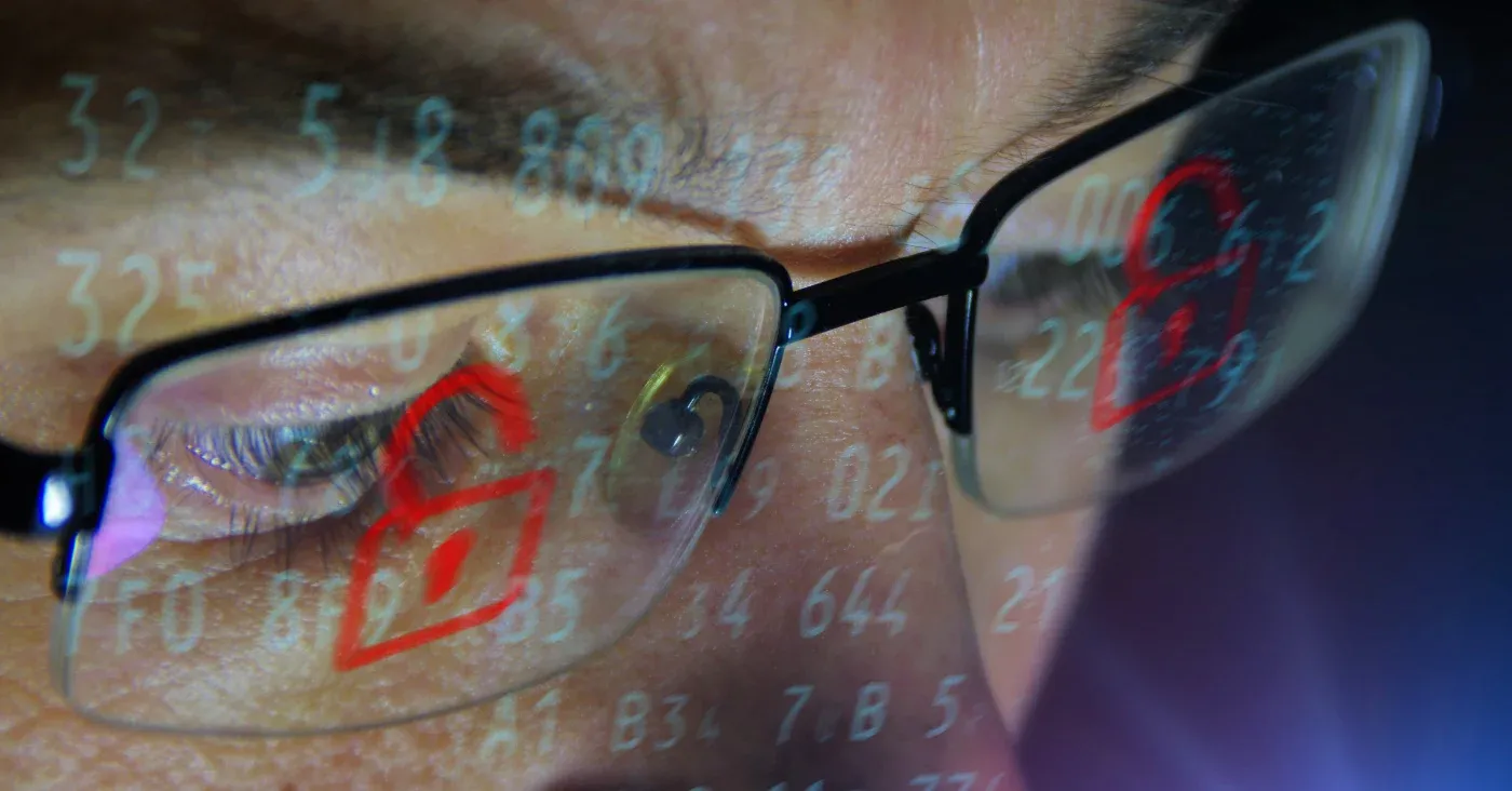 closeup glasses reflecting numbers and lock icons