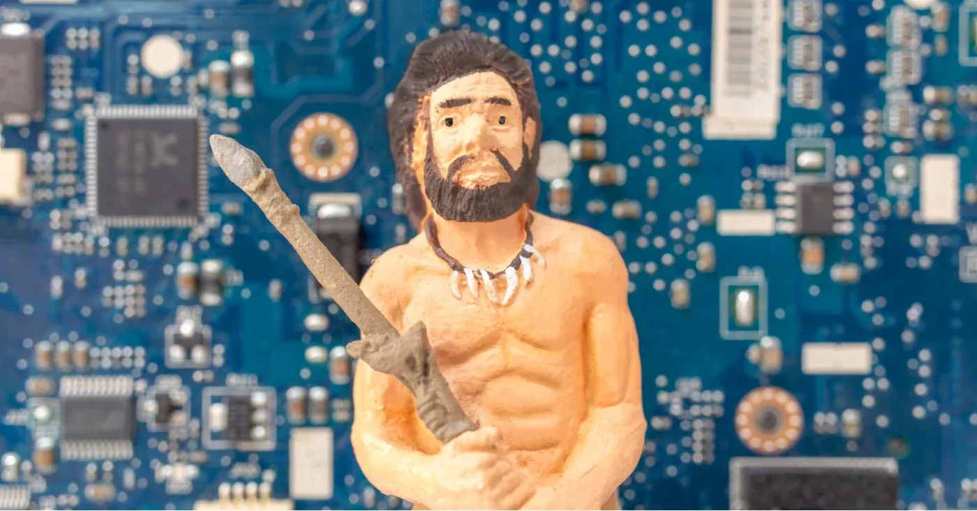 clay caveman figurine wielding a weapon stick
