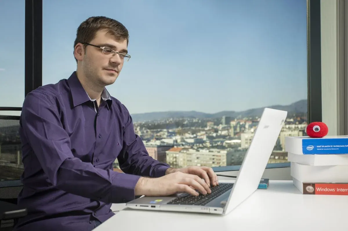 Tomislav Pericin working on a laptop in the office
