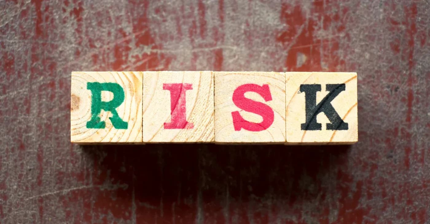 wooden blocks with letters spelling risk
