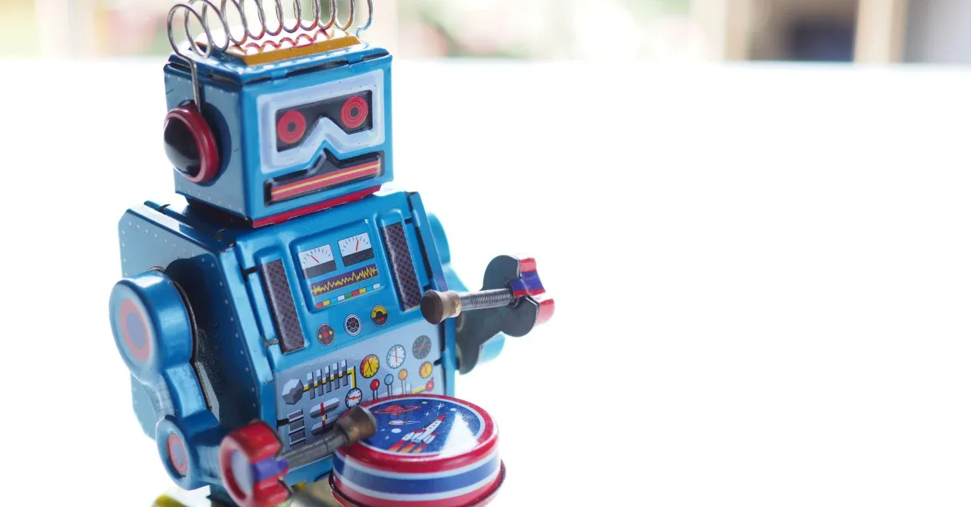 retro toy robot playing drum