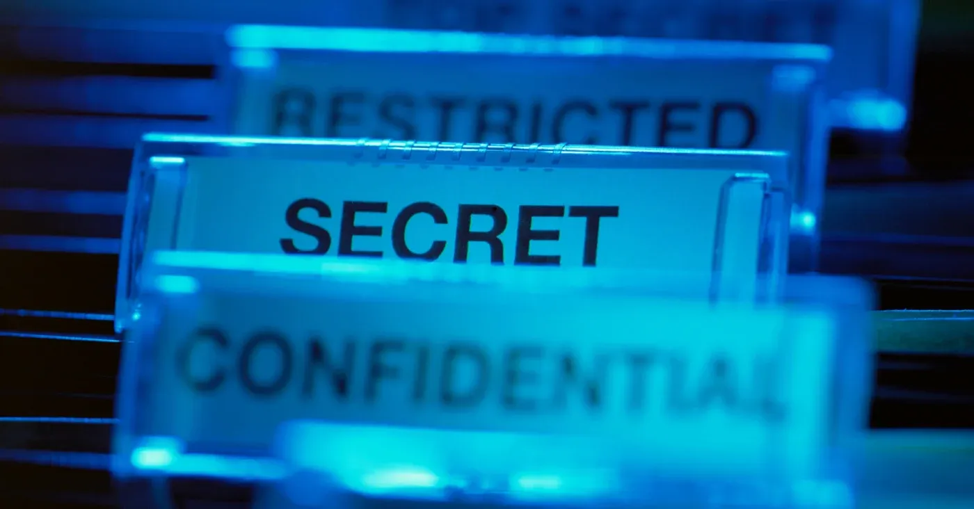 file folders labeled restricted, secret, confidential