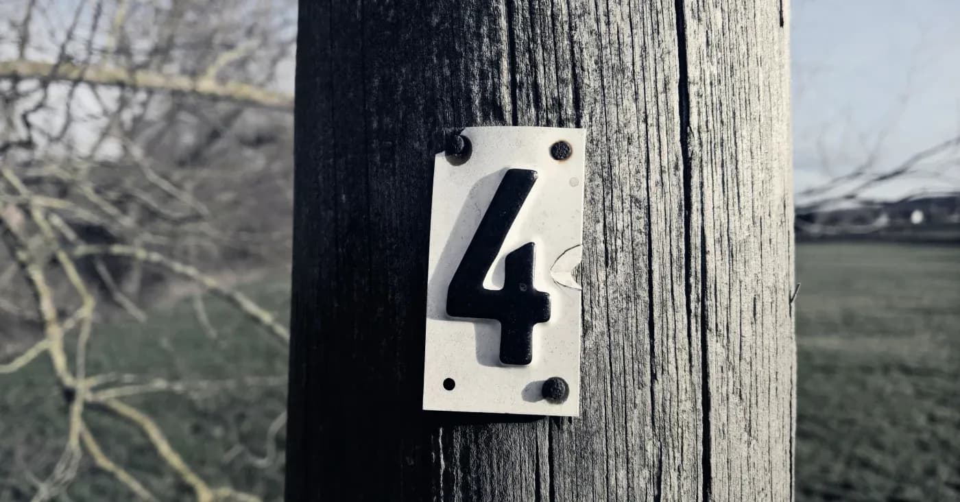 number 4 nailed to telephone pole