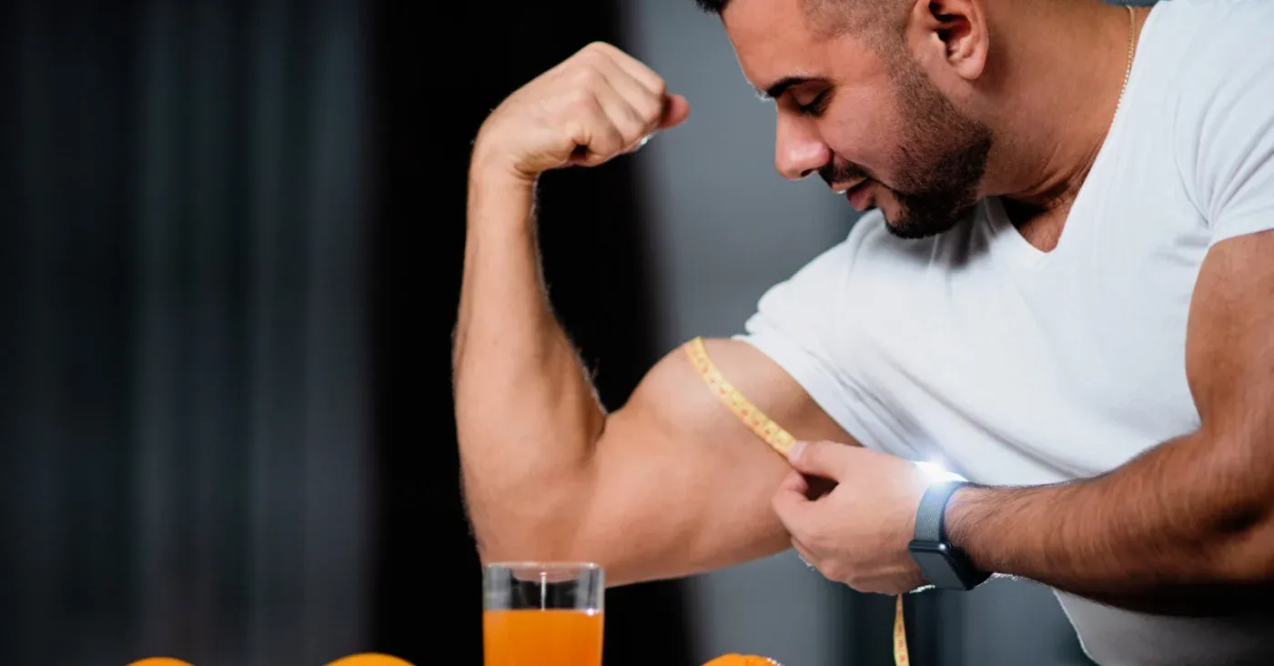 man measuring bicep