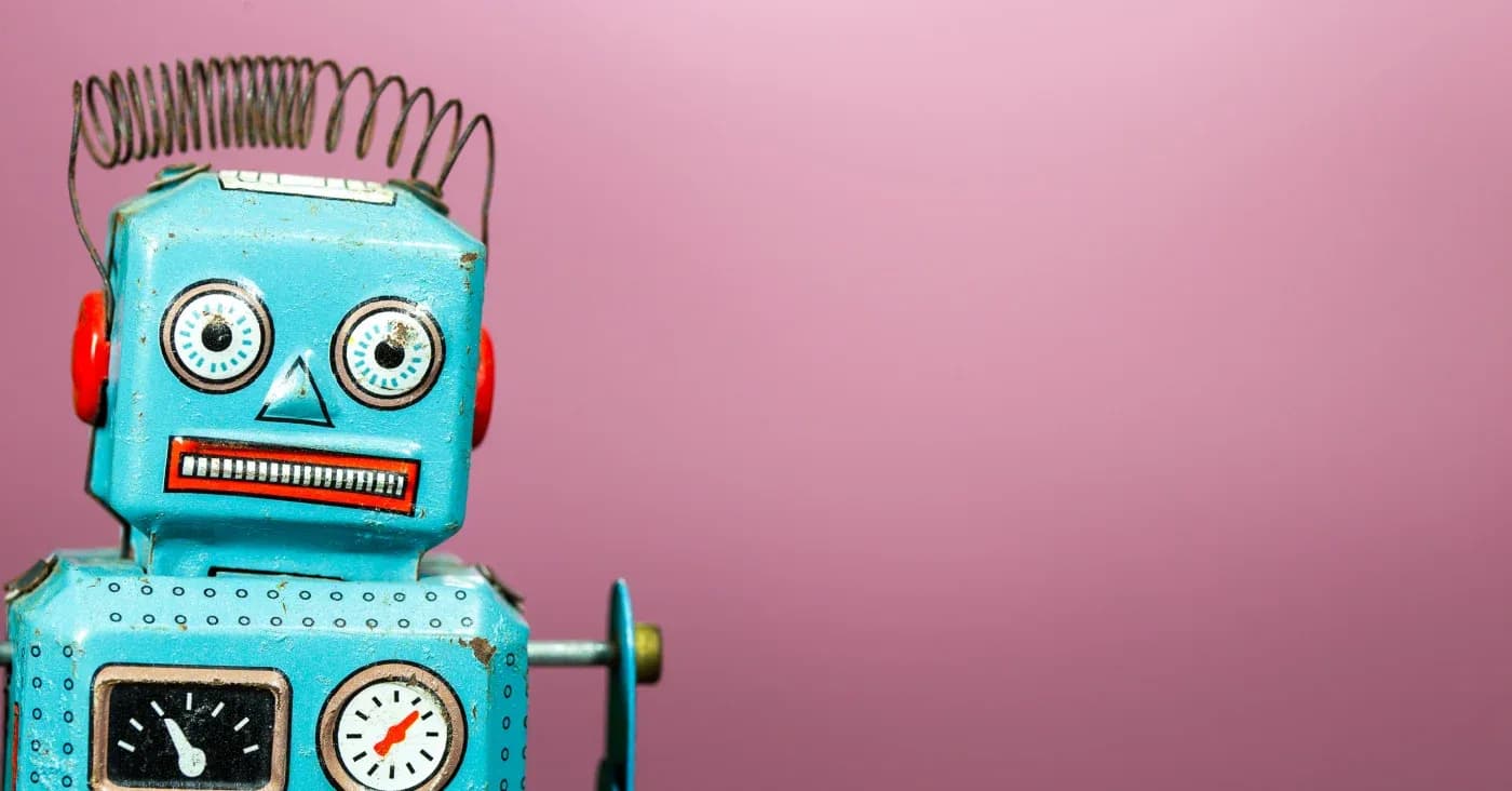 retro toy robot on pink background