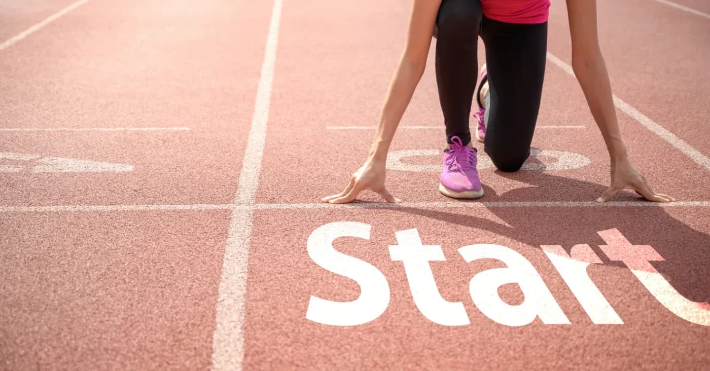 athlete in starting position on track