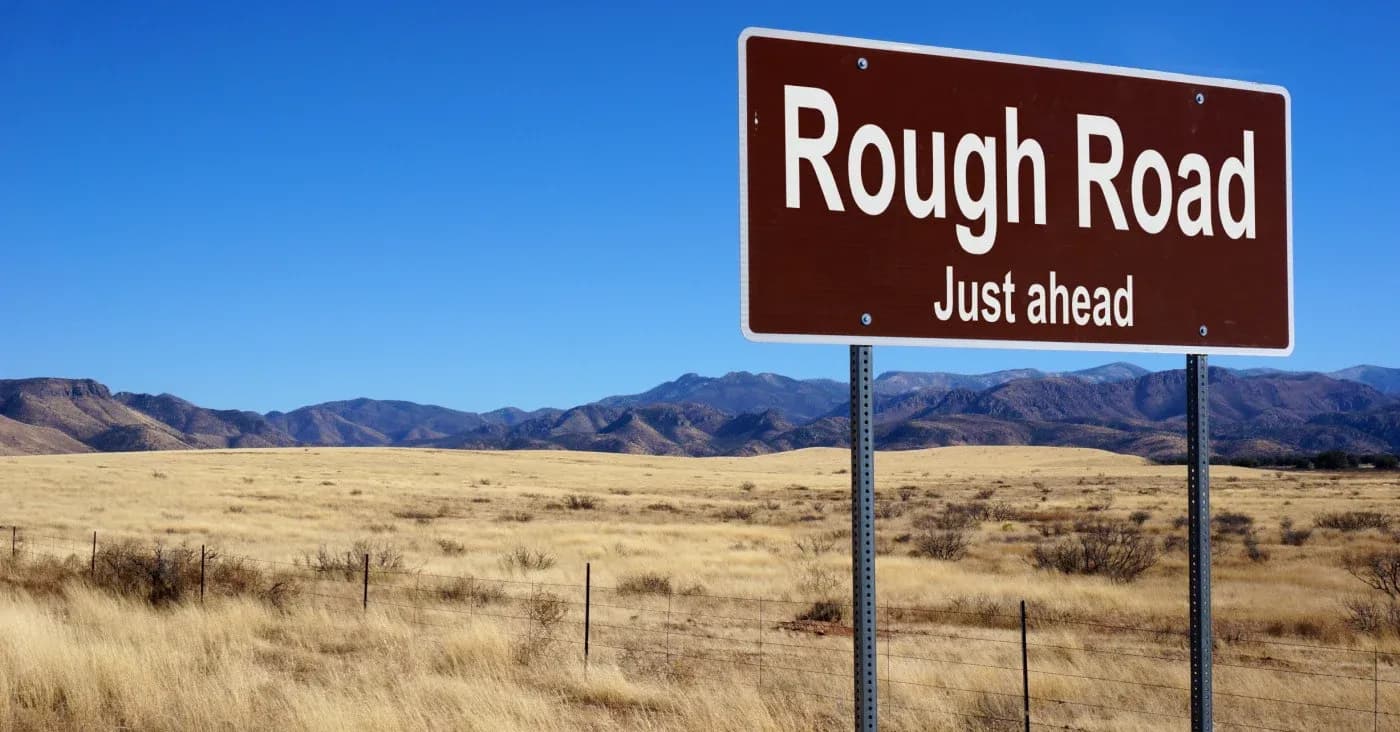 road sign warning rough road ahead