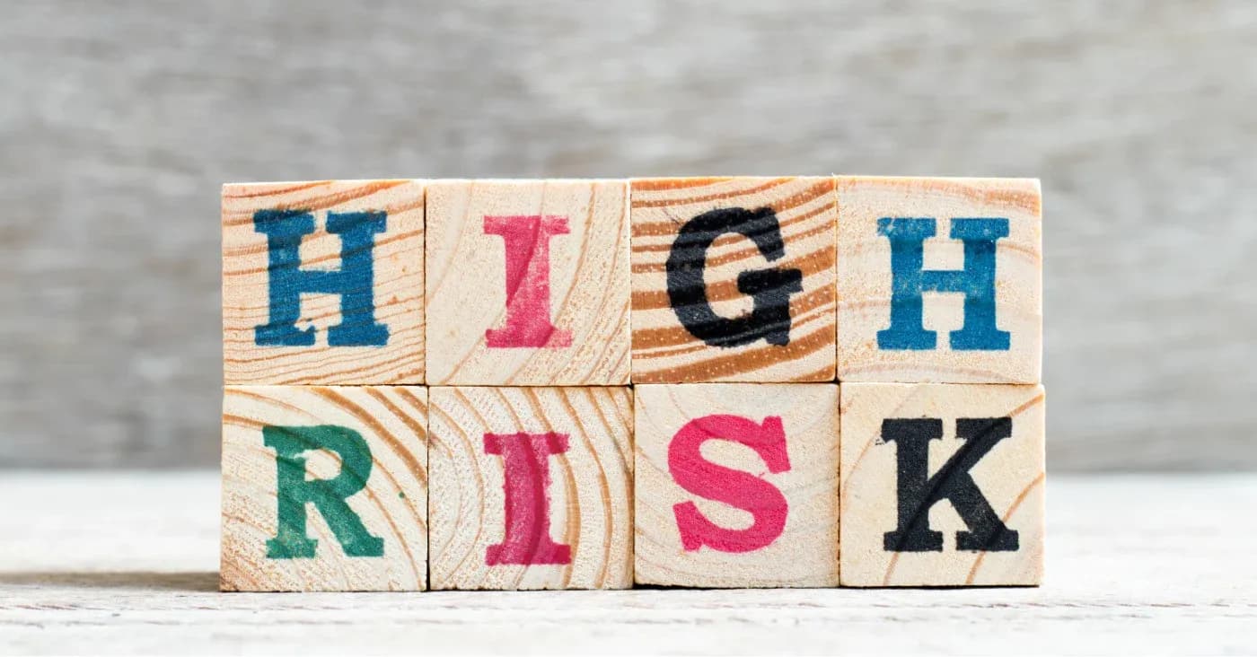 wooden blocks with letters spelling high risk