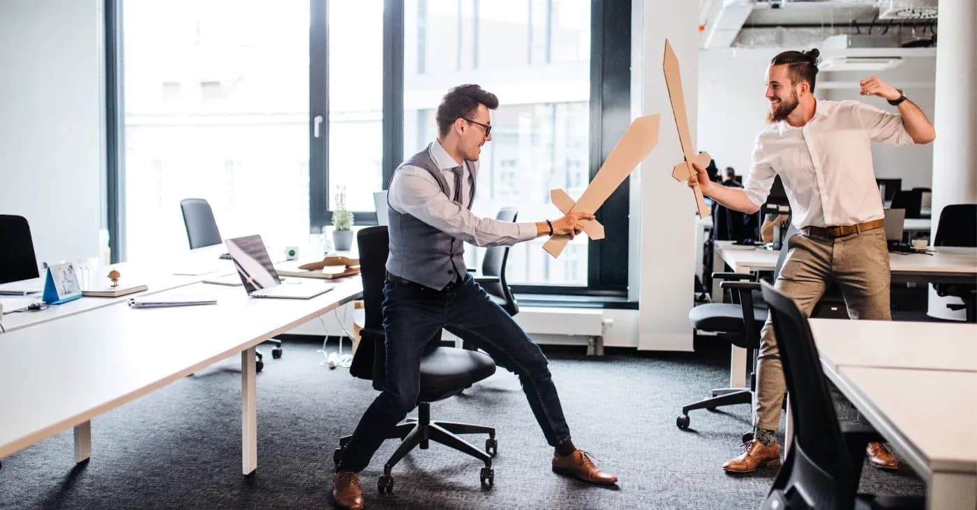 two men playing with wooden swords
