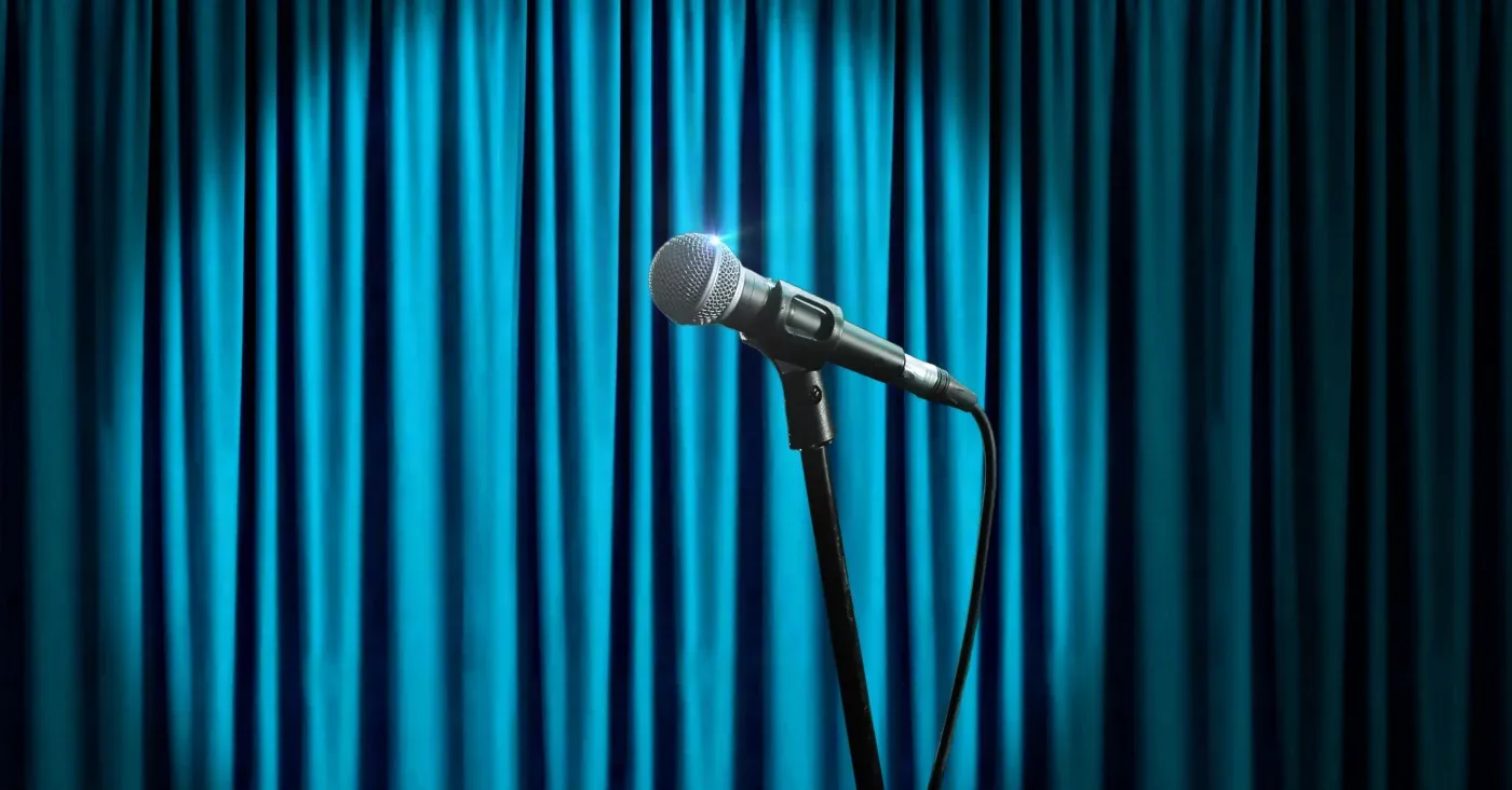 microphone in front of blue curtain
